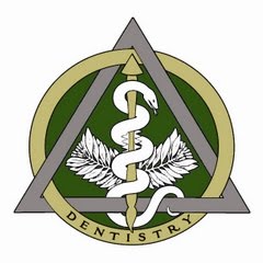 An emblematic logo featuring a stylized snake coiled around a staff, enclosed within a triangle with wings at the corners, and a banner beneath it bearing the word DENTISTRY .