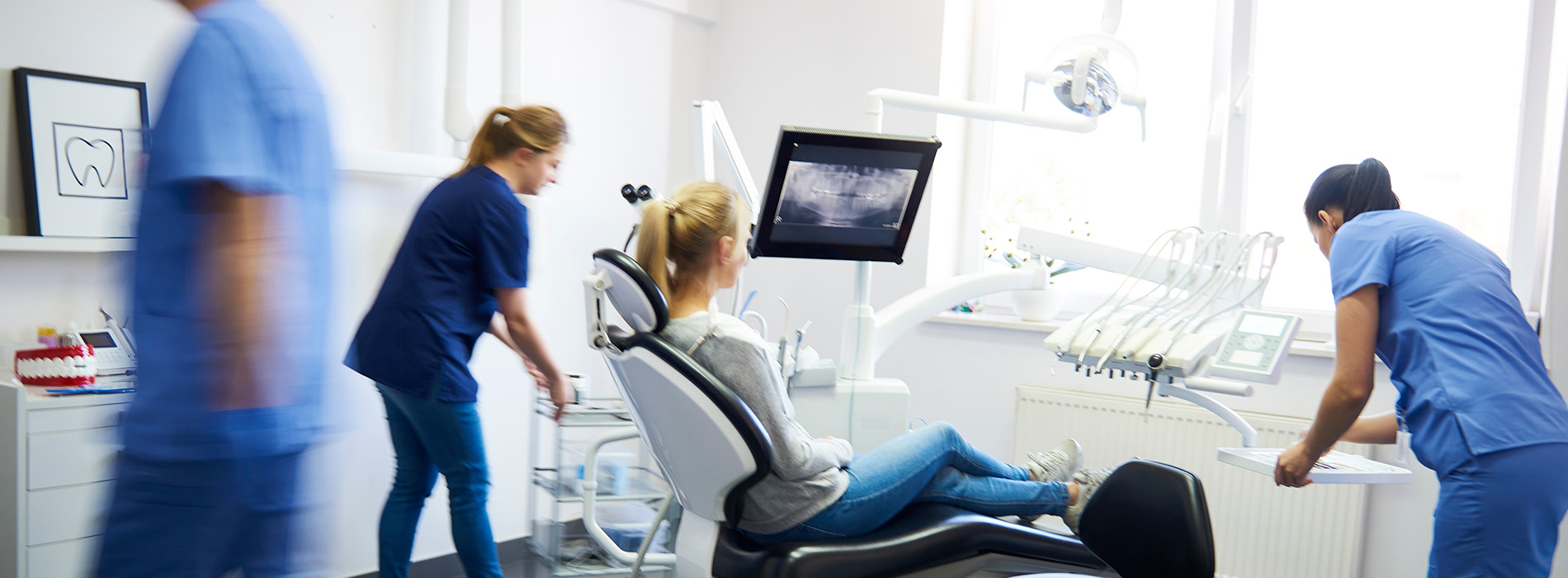 Medical professionals in a hospital setting, attending to patients and equipment.